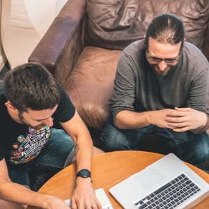 Two people working at a computer at Liquid Light